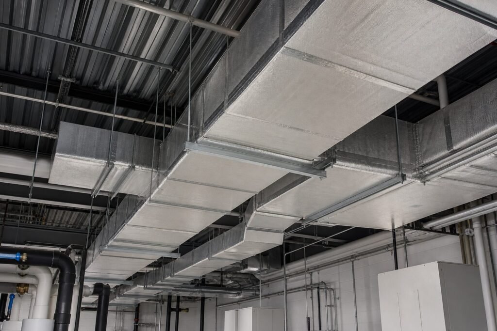 Professionally insulated rectangular HVAC ductwork in a commercial mechanical facility